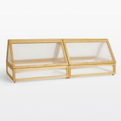 two glass cases sitting side by side on top of each other in front of a white background