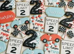 decorated cookies with race cars and numbers on them are displayed in front of a white background