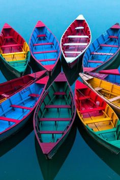 colorful boats are lined up in the water and ready to go out on the lake