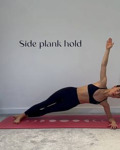 a woman doing a plank pose on a yoga mat with the words side plank hold above her