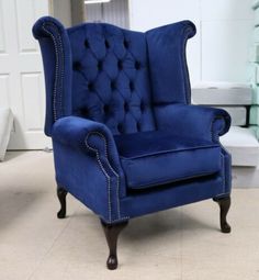 a blue chair sitting on top of a tile floor