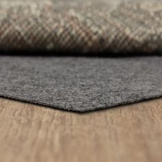 a close up view of the fabric on a wooden floor