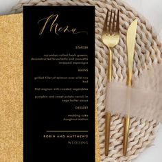 a black and gold menu card with two forks