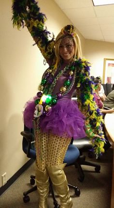 a woman dressed in costume standing next to a desk