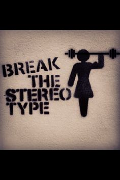 some stencils on the side of a wall with words and a woman lifting a barbell