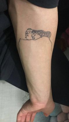 a person's foot with a tattoo on the left side of their leg, which has a drawing of a woman holding a baby in her arms