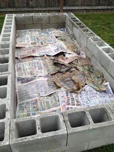 a pile of newspapers sitting on top of cement blocks