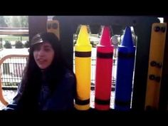 a woman is sitting in front of some colorful rockets