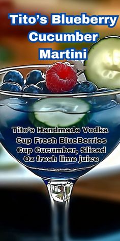 a blueberry cucumber martini is garnished with berries and cucumbers