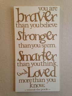 a white sign with brown lettering on it that says, you are braver than you believe