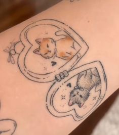 a tattoo with an image of two cats in a pocket