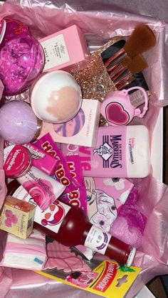 a pink bag filled with lots of makeup and beauty products on top of a table