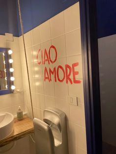 a bathroom with the word ciao amore written on the wall