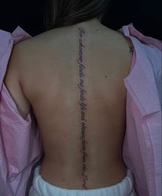 the back of a woman's neck with writing on it