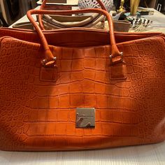 18” X 10”. Excellent Condition. Vibrant Orange Color. Comes With Internal Bag, Polish Cloth And Large Dust Cover. Elegant Orange Bag For Everyday Use, Designer Orange Bags For Formal Occasions, Elegant Orange Bag For Daily Use, Elegant Orange Shoulder Bag For Formal Occasions, Orange Tote Shoulder Bag For Formal Occasions, Elegant Orange Satchel For Travel, Elegant Orange Bag For Shopping, Elegant Orange Satchel With Detachable Handle, Formal Orange Satchel Shoulder Bag