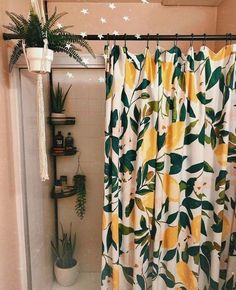 a bathroom with a shower curtain that has lemons on it and stars in the sky