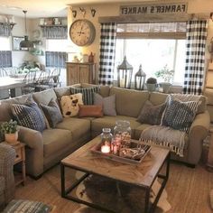 a living room filled with furniture and a large clock mounted to the wall above it