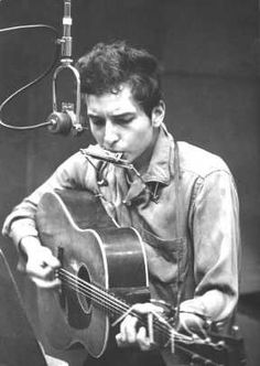 black and white photograph of man playing guitar