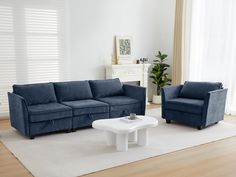 a living room with two blue couches and a white coffee table