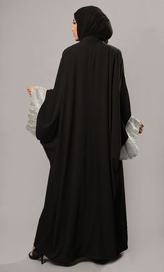 Featuring an asymmetrical and flared kaftan style abaya dress in nida fabric adorned with contrast color sequins embellishment on the edges of loose flowy sleeves. Its a beautiful eveing wear and trendy abaya dress.FIT : Relaxed fit.COMPOSITION : Nida.CARE : Dry clean only. Flowy Maxi-length Abaya For Eid, Flowy Long Abaya For Eid, Elegant Flowy Abaya For Eid, Elegant Black Cape Abaya, Floor-length Khimar For Eid, Elegant Black Tunic Abaya, Elegant Black Maxi Khimar, Elegant Black Maxi Length Khimar, Black Tunic Abaya For Eid