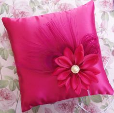 a pink pillow with a flower on it