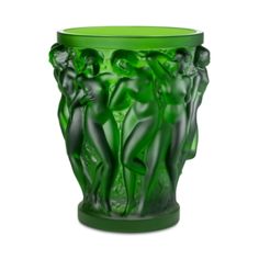 a green glass vase with three women on it