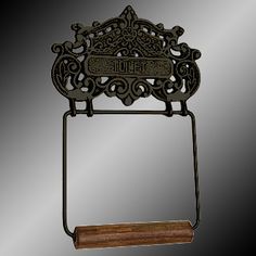 an old fashioned metal towel rack with a wooden holder on it's side and a mirror in the background