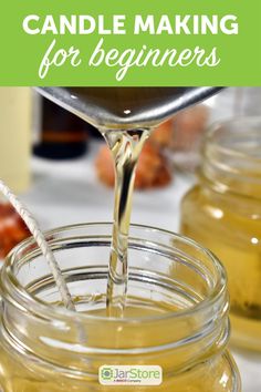 a jar filled with honey sitting on top of a table next to other jars and spoons