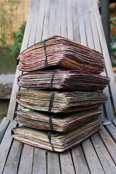 a stack of papers sitting on top of a wooden deck