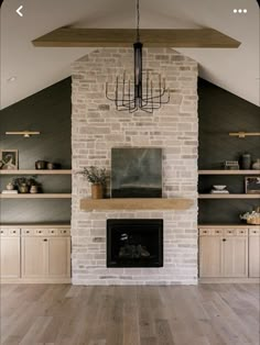 a living room filled with furniture and a fire place in front of a brick fireplace