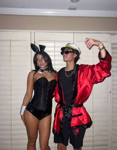 two people dressed up in costumes posing for the camera