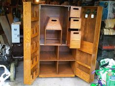 an open wooden cabinet in a garage