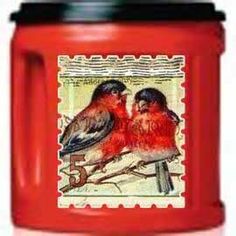 two birds are sitting on top of a red container with postage stamping around it