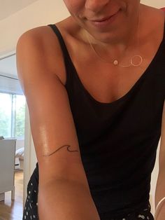 a woman with a small tattoo on her arm