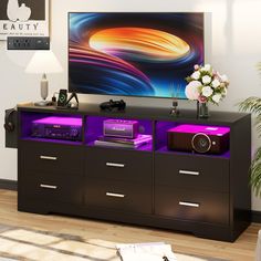 the entertainment center is decorated with purple and black furniture, along with a large painting on the wall