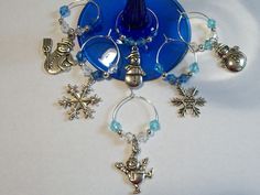 a blue glass object with silver charms and snowflakes