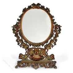 an ornately decorated mirror is shown against a white background