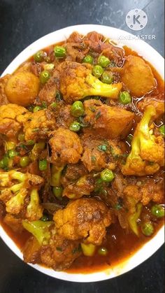 a white bowl filled with food on top of a table