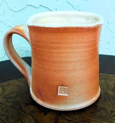 a coffee cup sitting on top of a wooden table