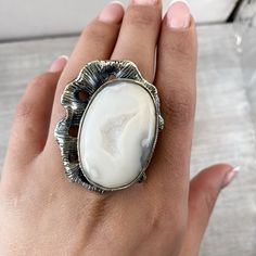 Large white agate ring Sterling silver, Druzy agate geode rings for women, Big ring asymmetric, white gemstone ring made in Armenia A huge and large ring in sterling silver 925 for women. The ring`s stone is natural druzy agate. One of a kind ring for unique women) The ring is absolutely handmade. All our jewelry is crafted with great attention to detail! We strive to provide you the best quality, modern design, and perfect look!! All our jewelry is made of high-quality sterling silver and is st Elegant White Jewelry With Large Stone, Modern White Opal Ring For Gift, Adjustable White Opal Open Ring, Unique White Jewelry With Natural Stones, Modern White Crystal Open Ring, White Gemstone Open Ring, White Moonstone Open Ring, Modern White Opal Gemstone Ring, Modern White Opal Ring