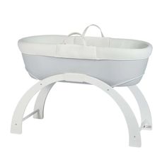 a white baby bassinet with a bow on it's head and handles