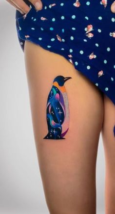 a woman with a penguin tattoo on her thigh