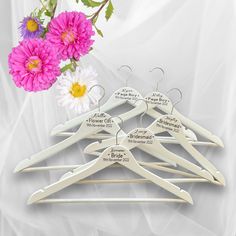 a bunch of clothes hangers with flowers in the background