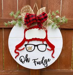 a wooden sign that says, oh fudge with glasses and a hat on it