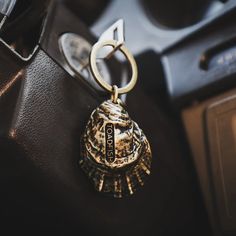 a close up of a keychain on a car dashboard