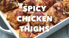 chicken thighs in a white casserole dish with the words spicy chicken thighs