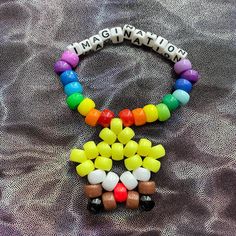 a necklace made out of candy and beads with the word happy written in letters on it