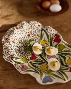 an egg is sitting on a plate with two eggs in the middle and another one behind it