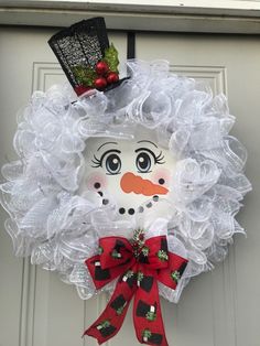 a wreath with a snowman face on it