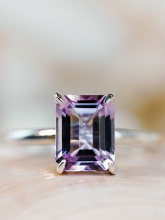 This classic solitaire setting contains a beautiful 2.5ct natural Rose De France amethyst. The emerald cut stone measures approximately 9x7mm and the band is 2mm wide. The ring is available in sterling silver, and 14k white, yellow, or rose gold.  This ring makes a unique promise or engagement ring.  Please send me a message if you need a size not listed.  *  This ring can be customized with any color center stone. All items are handmade by me in my shop in Manalapan, NJ.  Please message me with Luxury Lavender Amethyst Ring Elegant Style, Luxury Faceted Amethyst Ring In Fine Jewelry Style, Luxury Modern Amethyst Ring With Diamond, Luxury Fine Jewelry Silver Amethyst Ring, Luxury Classic Amethyst Ring With Gemstone Accents, Amethyst Engagement Ring White Gold, Amythest Engagement Rings, Emerald Cut Amethyst Ring, Lavender Amethyst Engagement Ring